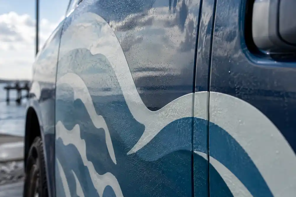A crisp business logo applied to a vehicle wrap, the kind of use that needs a vector file
